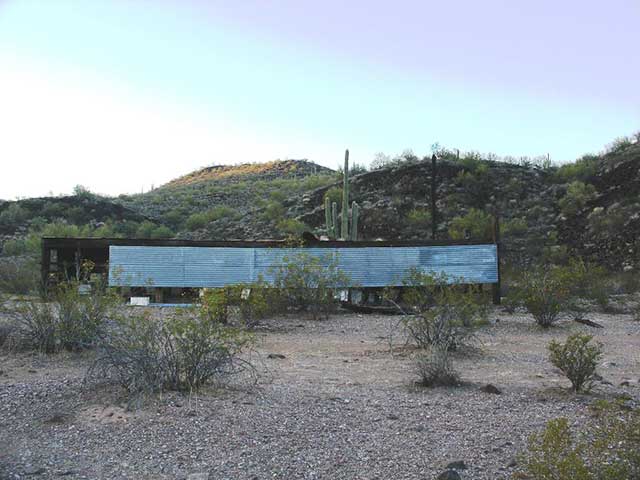 Abandoned structures can be ideal locations for concealing a tactical camp. In this photo, six vehicles are parked behind an abandoned beehive that is about 100 yards away from a 2-track road.