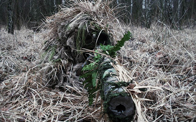 A ghillie suit and the proper application of camouflage can make a sniper almost invisible.