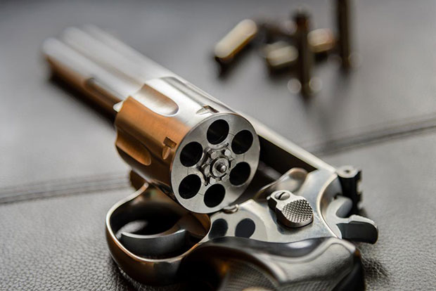 Even a cheap revolver is going to shoot a round that fits correctly in a cylinder chamber. New ammo or reloads, it does not matter.